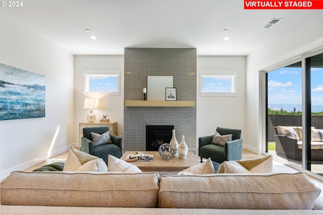 5133 N Benton Dr, Camas, WA 98607 - living room featuring healthy amount of natural light, a brick fireplace, baseboards, and recessed lighting
