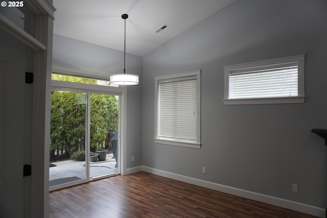 unfurnished room featuring vaulted ceiling and dark hardwood / wood-style flooring