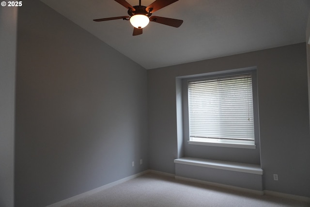 unfurnished room featuring ceiling fan, a wealth of natural light, carpet floors, and lofted ceiling