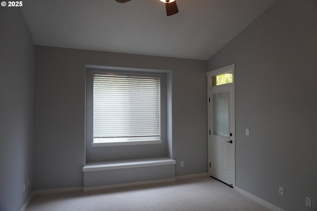 carpeted empty room featuring ceiling fan and lofted ceiling