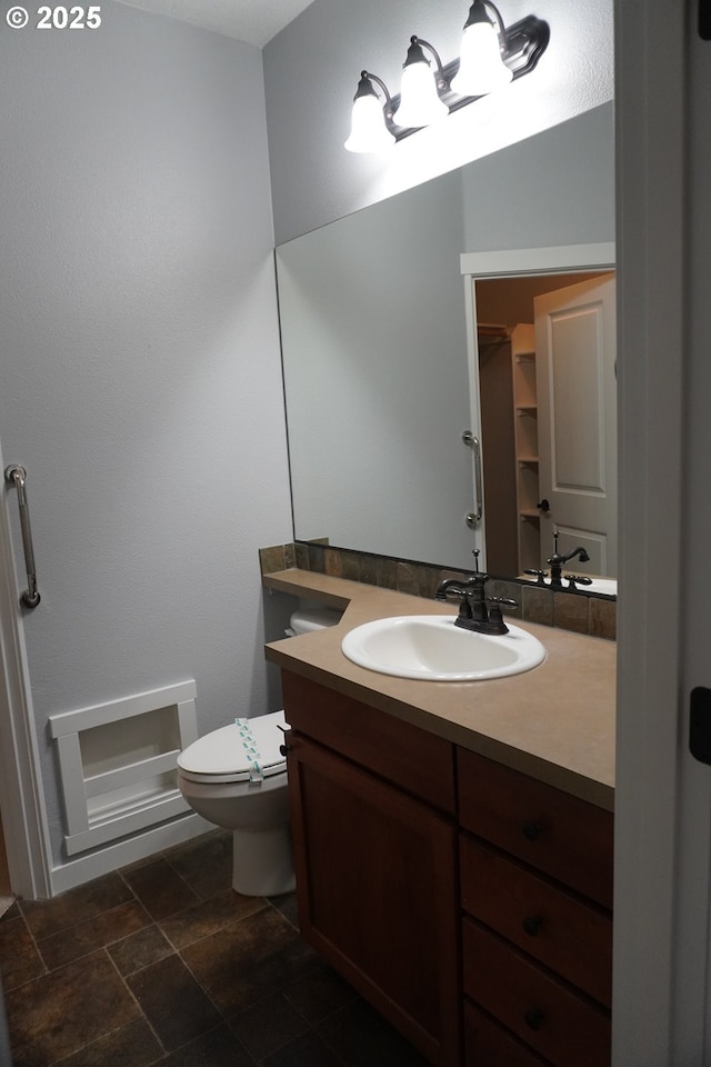 bathroom featuring toilet and vanity