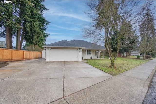 ranch-style home with a front lawn and a garage