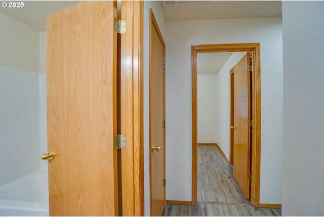 hallway with light wood-type flooring