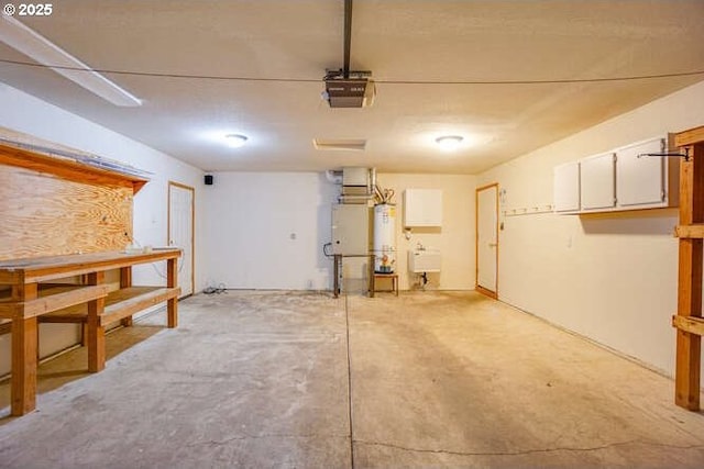 garage with water heater and a garage door opener