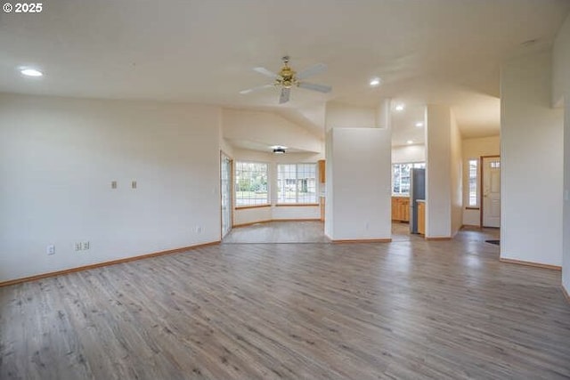 unfurnished living room with ceiling fan, hardwood / wood-style flooring, and vaulted ceiling