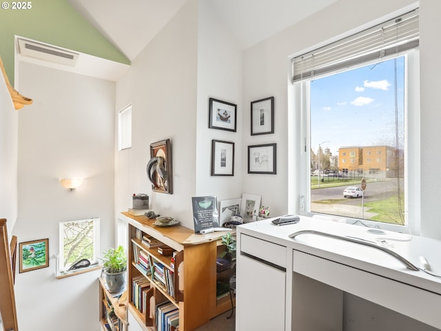 office space featuring lofted ceiling and visible vents