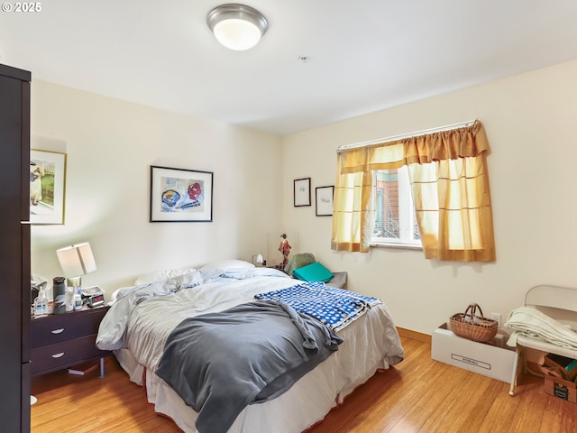bedroom featuring baseboards and wood finished floors