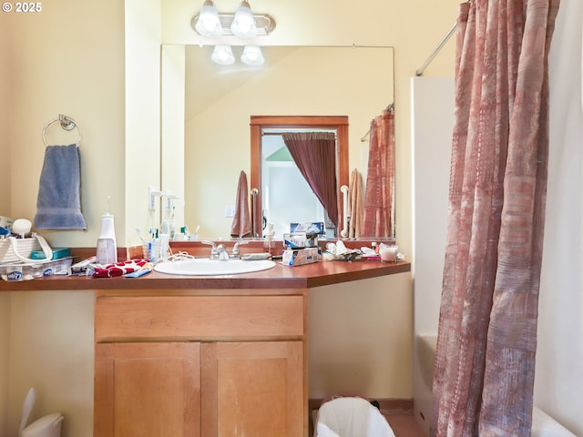 full bath featuring vanity and shower / bathtub combination with curtain