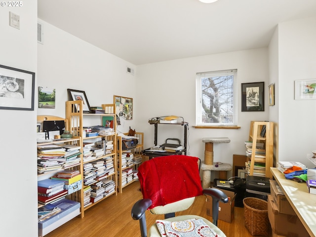 living area featuring wood finished floors and visible vents