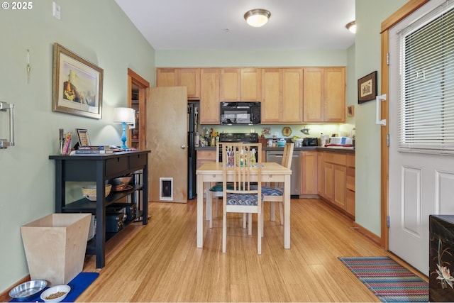4475 N Trenton St Unit 101, Portland, OR 97203 - kitchen featuring black appliances, light wood finished floors, and light brown cabinets
