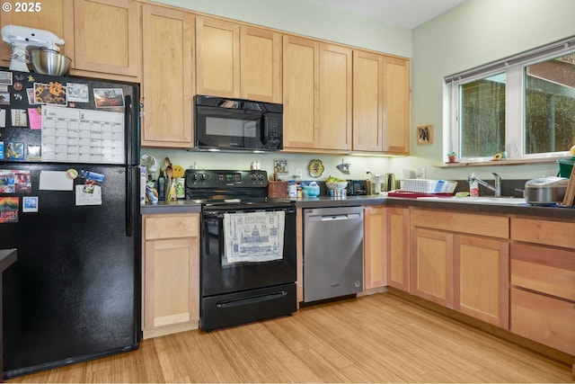 4475 N Trenton St Unit 101, Portland, OR 97203 - kitchen with black appliances, light brown cabinets, and light wood-style floors