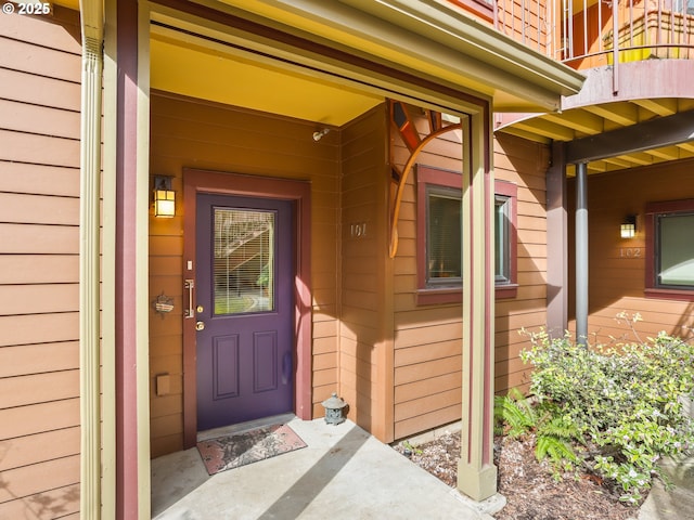 view of exterior entry featuring a balcony
