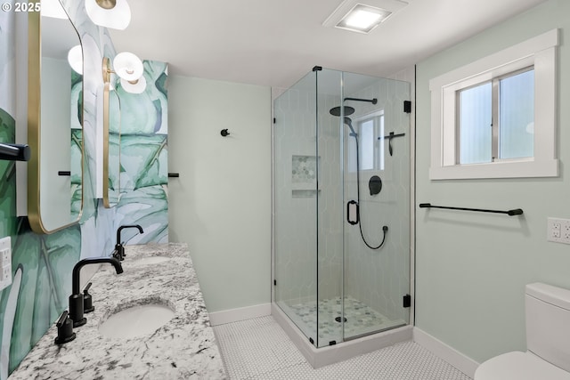 7505 SE 22nd Ave, Portland, OR 97202 - full bathroom with baseboards, toilet, a stall shower, double vanity, and tile patterned floors