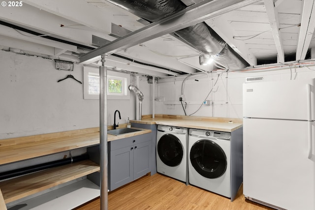 7505 SE 22nd Ave, Portland, OR 97202 - laundry area featuring washing machine and dryer and light wood-style floors