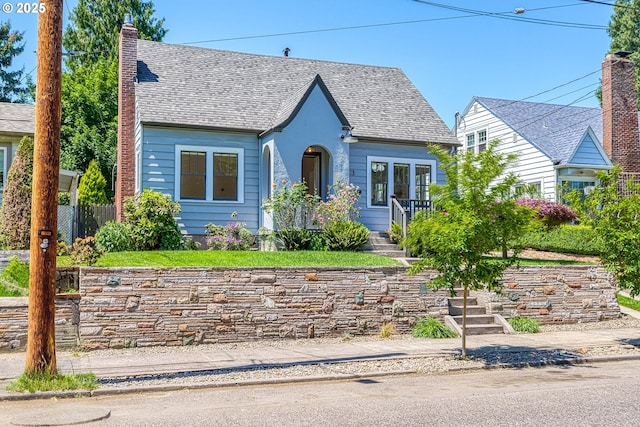 7505 SE 22nd Ave, Portland, OR 97202 - english style home featuring a chimney and roof with shingles