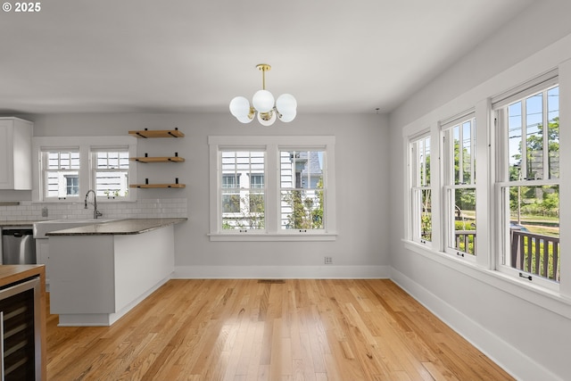 7505 SE 22nd Ave, Portland, OR 97202 - unfurnished dining area featuring beverage cooler, plenty of natural light, and a chandelier