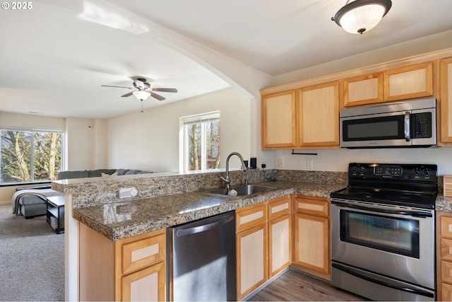 895 SW 170th Ave, Beaverton, OR 97006 - kitchen featuring stainless steel appliances, light brown cabinetry, a peninsula, a sink, and open floor plan