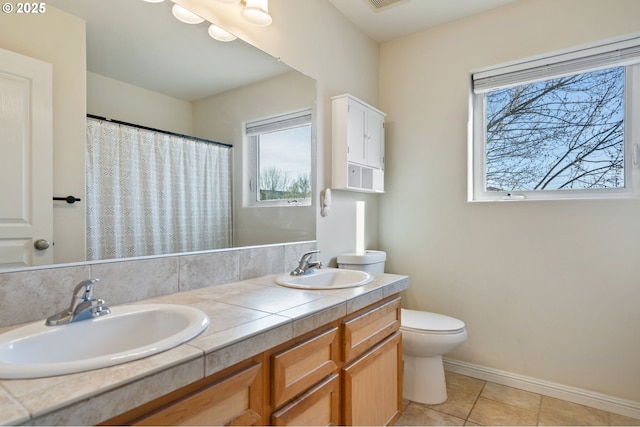 895 SW 170th Ave, Beaverton, OR 97006 - full bathroom featuring toilet, double vanity, baseboards, tile patterned floors, and a shower with curtain