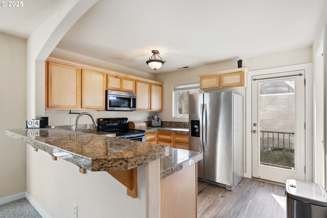 895 SW 170th Ave, Beaverton, OR 97006 - kitchen featuring appliances with stainless steel finishes, light brown cabinets, a peninsula, and plenty of natural light