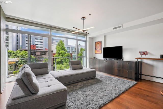 1221 SW 10th Ave Unit 410, Portland, OR 97205 - living area featuring wood finished floors, a chandelier, and plenty of natural light