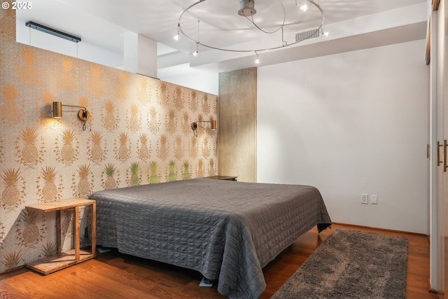 1221 SW 10th Ave Unit 410, Portland, OR 97205 - bedroom featuring rail lighting and wood finished floors