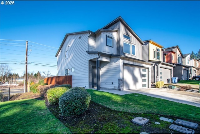 view of front of house featuring a garage and a front lawn