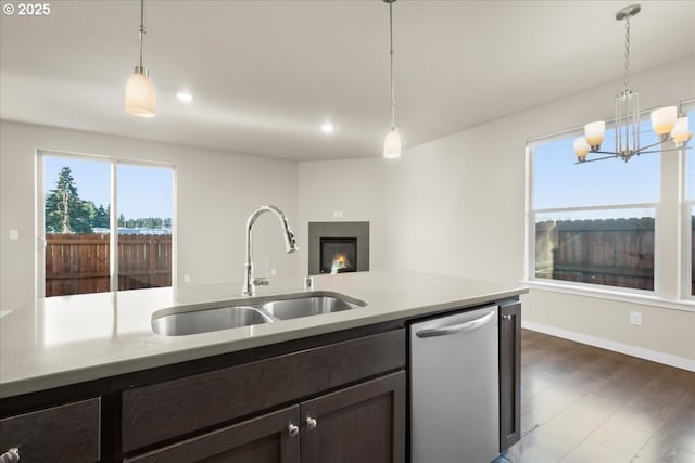 kitchen with dishwasher, hanging light fixtures, a sink, and dark wood-style floors