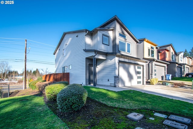 view of front of home featuring a garage, a front yard, and driveway