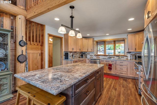 161 Acme Rd, White Salmon, WA 98672 - kitchen featuring appliances with stainless steel finishes, a sink, backsplash, a center island, and light stone counters