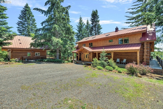 161 Acme Rd, White Salmon, WA 98672 - back of house featuring a standing seam roof, metal roof, log exterior, and a chimney