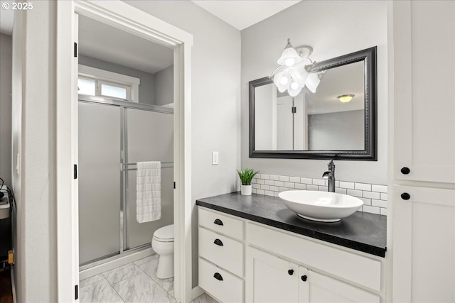 bathroom with toilet, an enclosed shower, tasteful backsplash, and vanity