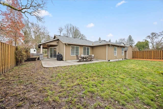 rear view of house featuring a patio and a lawn