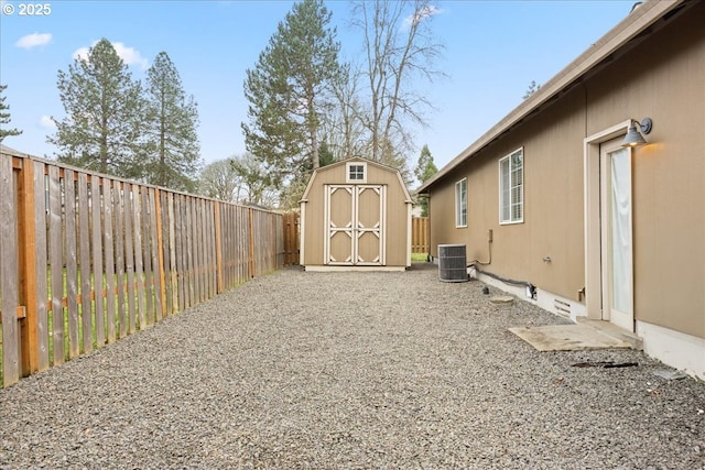 view of yard featuring central AC and a storage unit