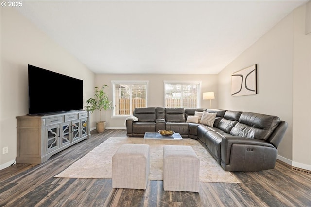 living room featuring lofted ceiling and dark hardwood / wood-style flooring