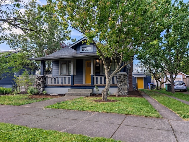 7035 NE Klickitat St NE, Portland, OR 97213 - view of front of home with covered porch and a front lawn