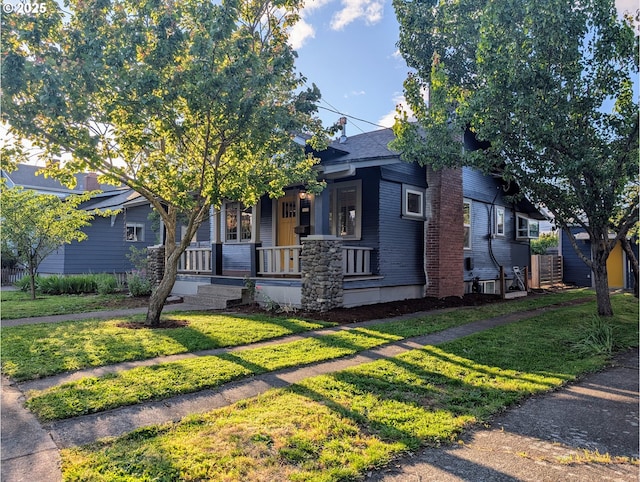7035 NE Klickitat St NE, Portland, OR 97213 - view of front facade featuring covered porch and a front lawn