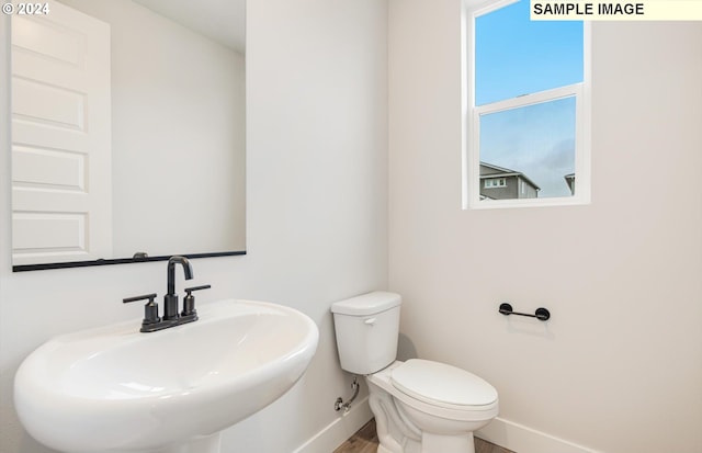 bathroom featuring toilet and sink