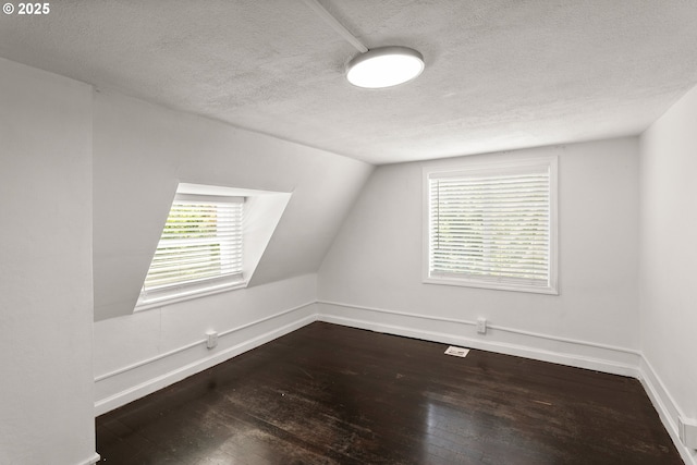 11744 SW 61st Ave, Portland, OR 97219 - additional living space with a textured ceiling, dark wood-style flooring, healthy amount of natural light, and vaulted ceiling