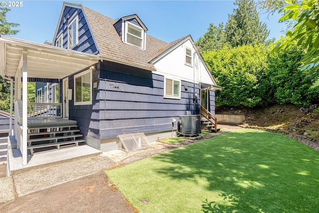 11744 SW 61st Ave, Portland, OR 97219 - view of side of home featuring a yard, roof with shingles, and entry steps