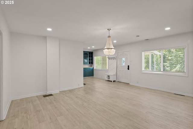 11744 SW 61st Ave, Portland, OR 97219 - unfurnished living room with a chandelier, light wood-style floors, and recessed lighting