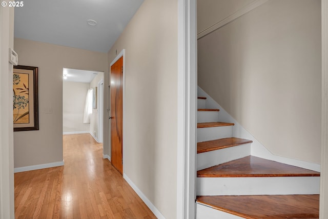 stairs featuring baseboards and wood finished floors