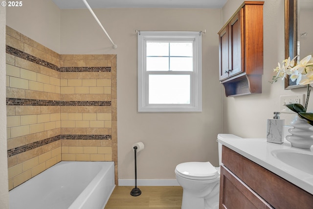 full bathroom with vanity, baseboards, toilet, and  shower combination