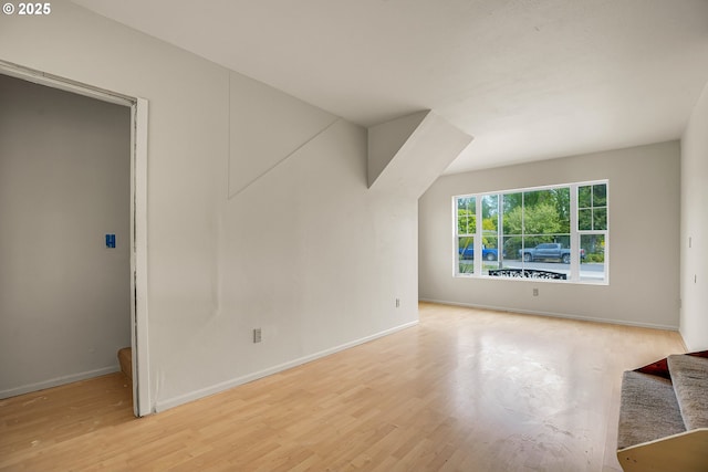 interior space with baseboards, light wood-style flooring, and stairway
