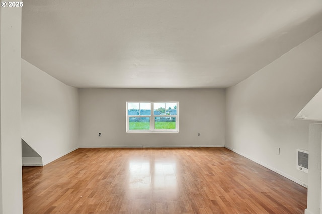 unfurnished room with light wood-type flooring and baseboards