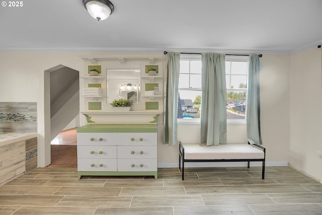 interior space with crown molding and wood tiled floor