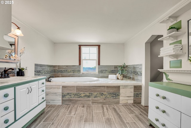 bathroom with a garden tub, crown molding, wood finished floors, and vanity