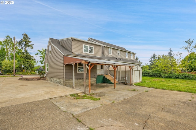 view of front of home featuring an outbuilding and a shed