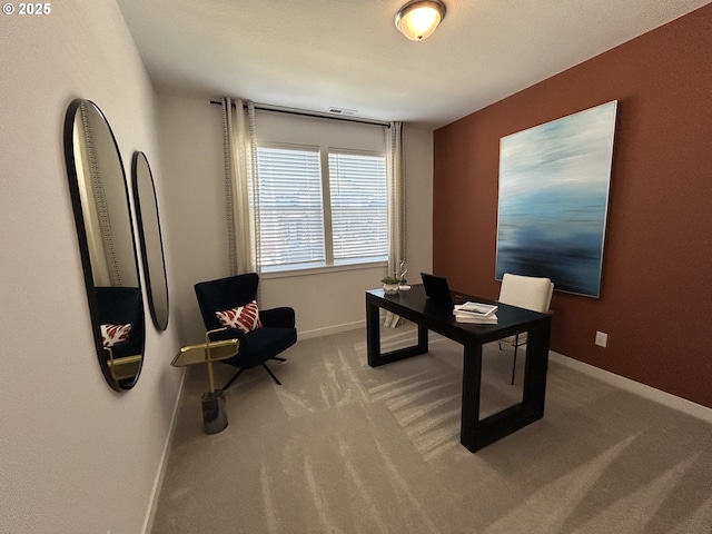 office space with carpet floors, baseboards, and visible vents