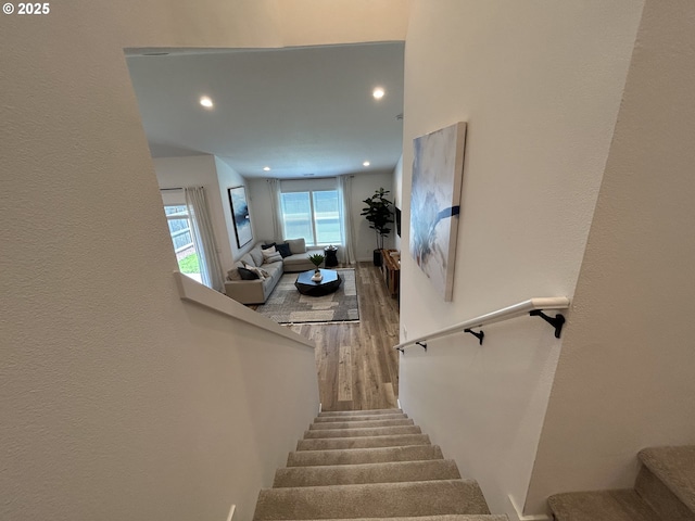 staircase featuring recessed lighting and wood finished floors