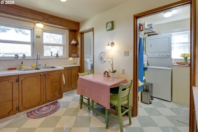 dining area featuring light floors and stacked washer and clothes dryer